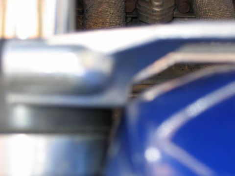 1985 Ford Crown Victoria LTD - A detailed view of an engine part, showing metallic textures and a vibrant blue casing.