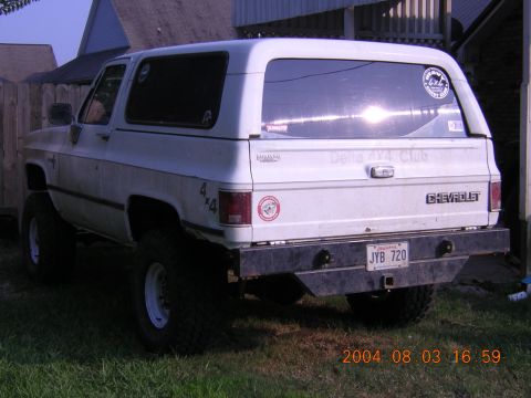 1984 Chevrolet Blazer - This white Chevrolet K5 Blazer, likely from the early 1980s, is equipped with an aftermarket bumper and off-road tires.