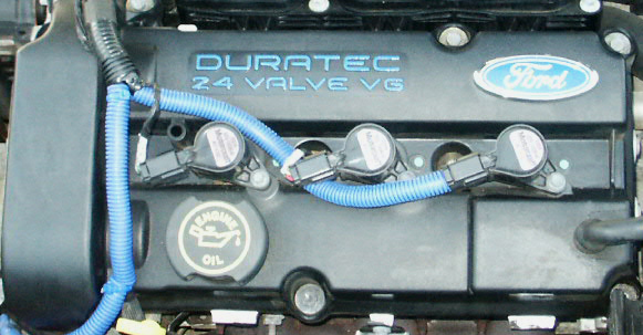 Ford Duratec 24 Valve V6 engine cover with blue spark plug wires and Ford logo