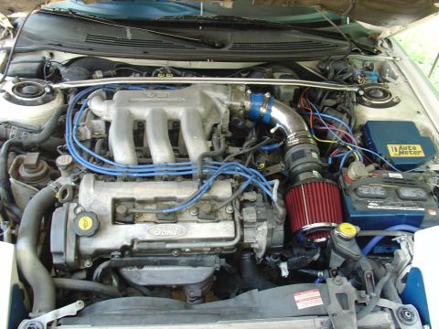 1993 Ford Probe - The engine bay of a 1993 Ford Probe, its V6 engine and an aftermarket air intake system.