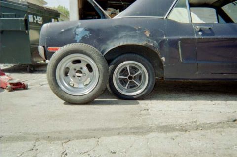 1968 Ford Mustang - That fender was smashed in & would'nt let these tire's fit, But a little time with a bottle jack & Now they fit! The guy gave me these whee…