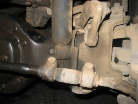 1988 Ford Bronco - Detail of a vehicle's suspension system, showing wear and tear on various components.