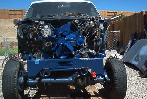 1986 Ford Bronco - This Ford Bronco chassis is undergoing restoration, with its engine bay stripped and frame painted blue.