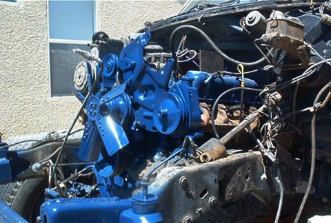 1986 Ford Bronco - Engine bay components, including the fan and master cylinder, are painted bright blue.