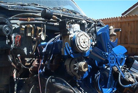 1986 Ford Bronco - Close-up of an engine bay showing various parts painted blue.