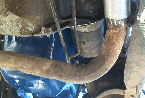 1986 Ford Bronco - Undercarriage view showing an exhaust pipe and part of the drivetrain, with a Supermotors.net watermark.
