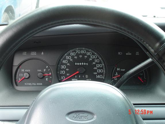 1999 Ford Crown Victoria dashboard showing speedometer, fuel gauge, voltmeter, and temperature gauge