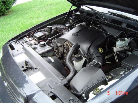 1999 Ford Crown Victoria - Close-up view of the engine compartment, revealing various components and wiring.