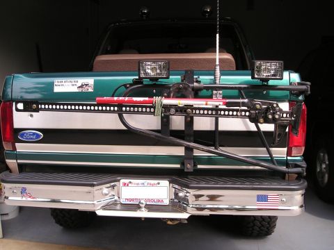 1996 Ford Bronco - Rear view of a green Ford truck with an external carrier mounted on the tailgate.
