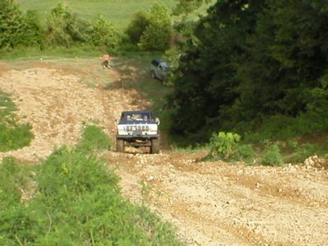 1979 Ford F-150 - A 1979 Ford F-150 navigates a rough, unpaved incline with another vehicle following.