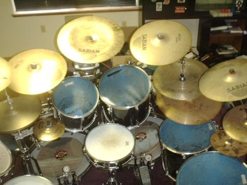 1978 Ford Bronco - A drum set is shown with multiple cymbals and blue drum heads.