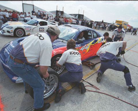 1995 Ford Mustang - Race cars are serviced in the pit lane during a competition.