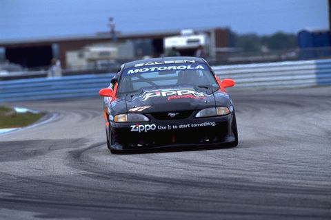 1995 Ford Mustang - A 1995 Ford Mustang race car, adorned with Zippo and Motorola sponsorship, navigates a turn on a race track.