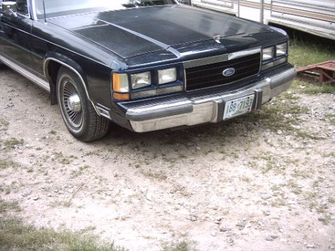 1990 Ford Crown Victoria LTD - Front view of a dark blue 1990 Ford Crown Victoria LTD, a chrome grille and a license plate reading 188-7193.