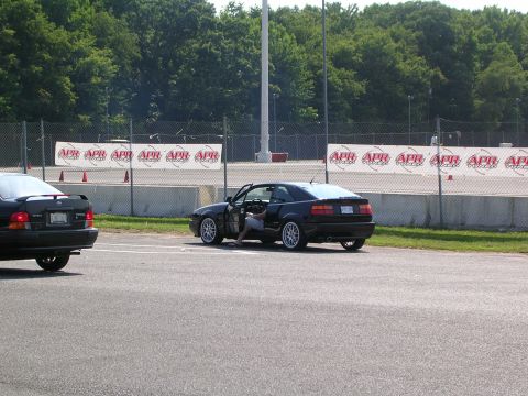 1990 Jeep YJ - A black Volkswagen Corrado is parked on a track with its door open, with another car nearby.