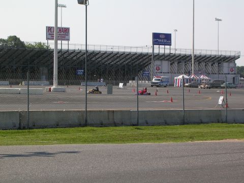1990 Jeep YJ - Go-karts race around a track with an ambulance and tents visible near the grandstands.