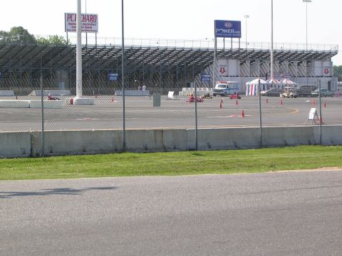 1990 Jeep YJ - Go-karts compete on a track with grandstands and tents visible.