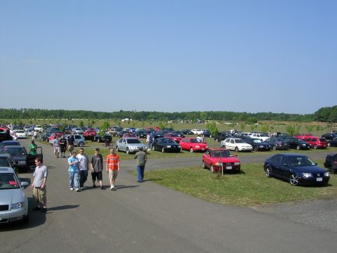 1990 Jeep YJ - A large gathering of cars parked at an outdoor event on a sunny day.