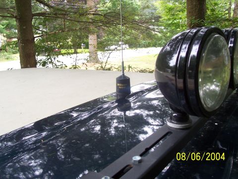 1994 Ford Bronco - Close-up of vehicle roof accessories, including an antenna and auxiliary lights, with a date stamp visible.