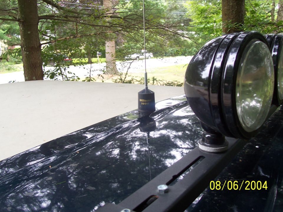Wilson 1000 CB antenna and round black off-road lights on truck roof light bar