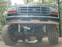 1995 Ford Bronco - Rear view of a modified SUV with large tires and visible suspension parts.