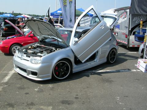 1990 Jeep YJ - Modified silver Volkswagen Golf with custom doors displayed at an outdoor event.