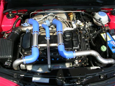 1990 Jeep YJ - Customized engine bay features prominent blue silicone hoses and polished metal piping for the turbo system.