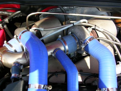 1990 Jeep YJ - Close-up view of an engine bay, highlighting turbochargers and custom blue hoses.
