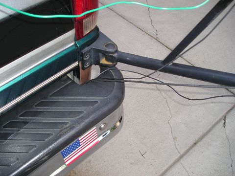 1996 Ford Bronco - Close-up of the rear bumper and taillight of a green 1996 Ford Bronco, showing an American flag decal.
