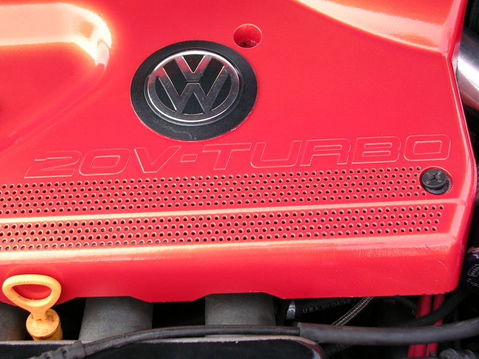Red Volkswagen 20V-TURBO engine cover with chrome emblem