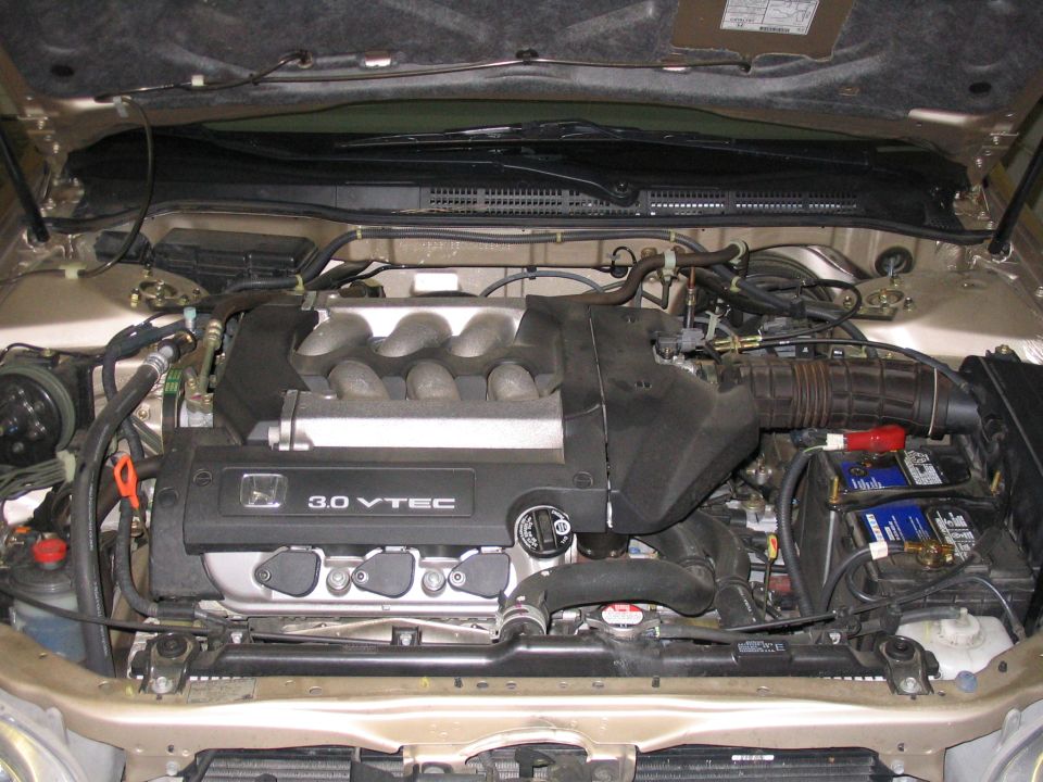 Honda 3.0 VTEC V6 engine bay in a gold sedan, hood open, overhead view