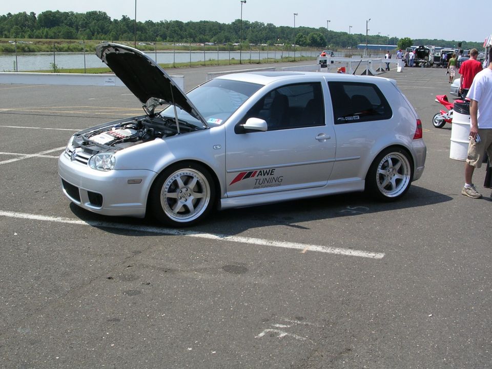 Silver Volkswagen Golf GTI with hood open, showing engine. Has 'AWE TUNING' sticker on the side