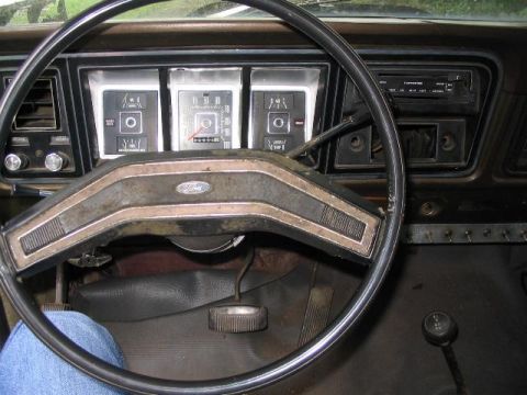 1979 Ford F-250 - The interior of a 1979 Ford F-250 pickup truck, the dashboard and steering wheel.