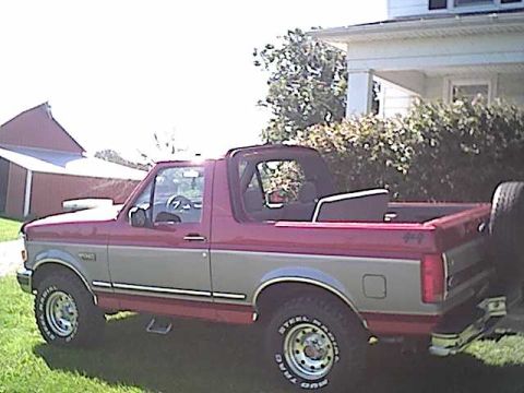 1994 Ford Bronco - This 1994 Ford Bronco features a two-tone red and silver paint scheme and a removable top.