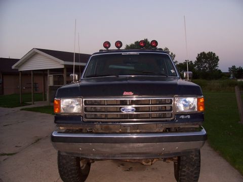1989 Ford Bronco - This 1987 Ford Bronco is shown from the front with a chrome bumper and roof-mounted lights.