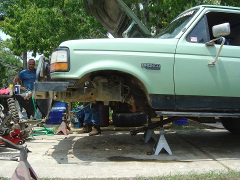 1993 Ford Bronco - This 1993 Ford Bronco is undergoing front-end work, with the hood open and parts removed.