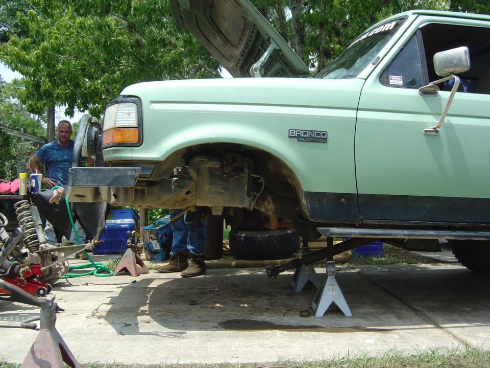 1993 Ford Bronco with hood up, on jack stands, front end disassembled