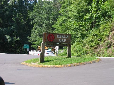 1985 Ford LTD Crown Victoria - A white sedan and a white pickup truck are visible near the Deals Gap sign on a sunny day.