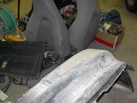 1993 Ford Probe - Workshop scene with car seats, parts, and a bumper in the foreground.