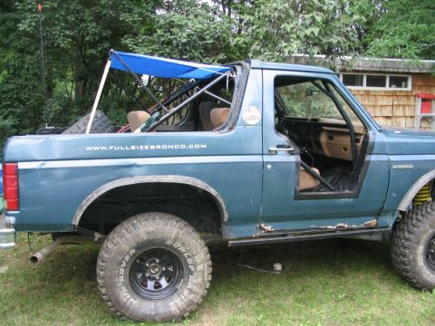 1986 Ford Bronco - take the tie downs off, fold the arms up against the cage tubes, zip tie them and it's all gone .. will need pic of it folded up