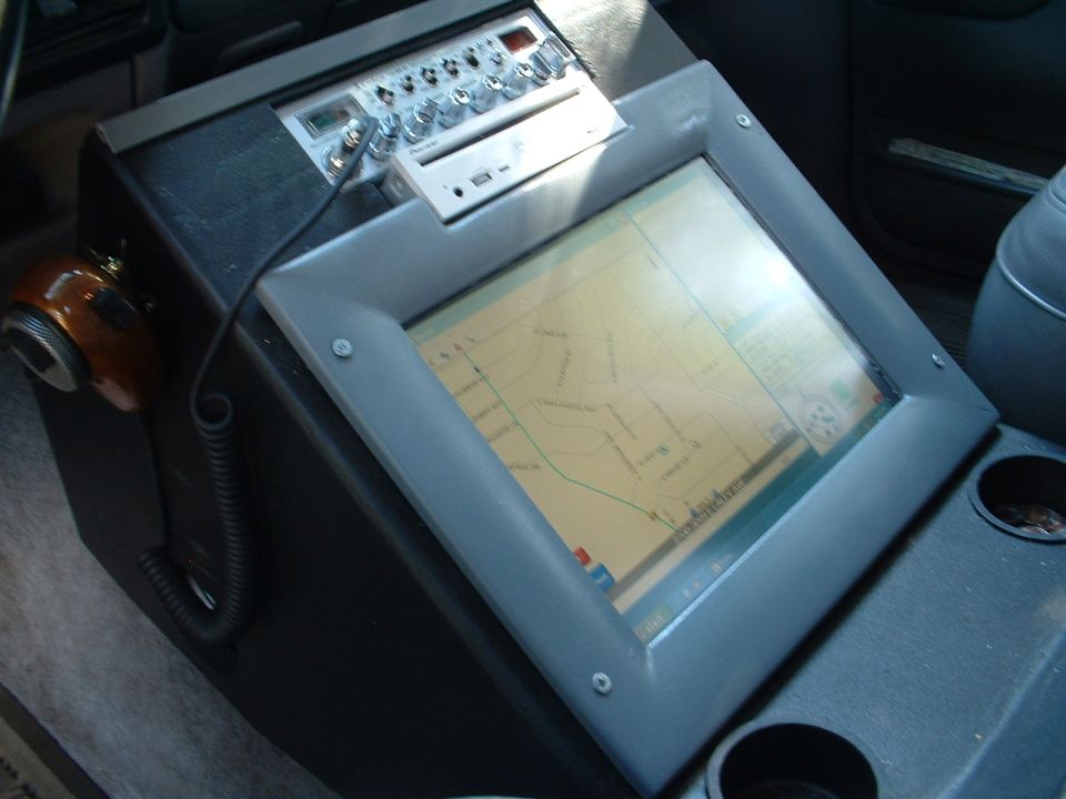 Vehicle center console with map touchscreen, Pioneer stereo, and CB radio mic