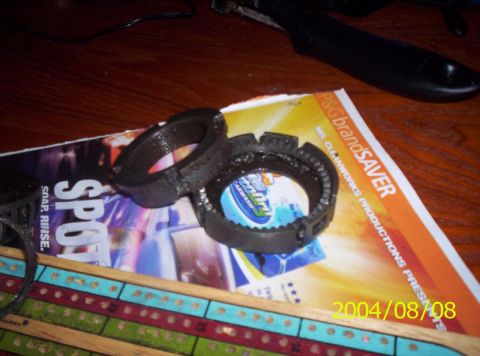 1986 Ford Bronco - Two metal rings with teeth are placed on top of a magazine with text and images.
