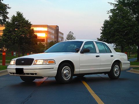 2000 Ford Crown Victoria - A white 2000 Ford Crown Victoria is shown from the front three-quarter angle.