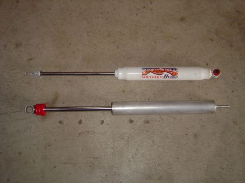 1978 Ford Bronco - Two shock absorbers are shown, one white with red top and the other silver with red top.
