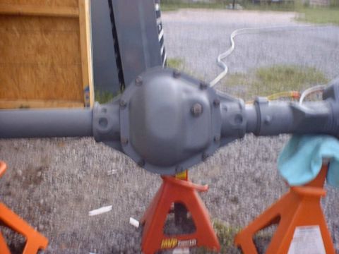 1988 Ford Bronco - Rear axle assembly on jack stands, likely being prepped for installation or repair.