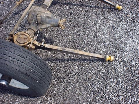 1988 Ford Bronco - Dana 44 front axle assembly and tire shown on a gravel surface.