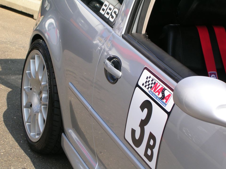 Silver car side view with racing number 3B and NASA decal
