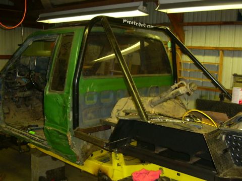 1990 Ford Bronco - This custom truck build features a roll cage and extensive modifications, with the interior stripped down for work.