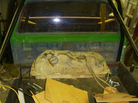1990 Ford Bronco - Interior view of a green truck bed showing a fuel tank and roll cage structure.