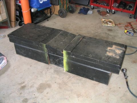 1986 Ford F-150 - Three black metal toolboxes are arranged on a concrete floor in a garage setting.
